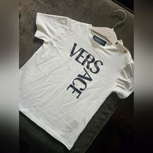 Versace Kids Tee in White with Bold Logo Small Yellowish Stain In Front.